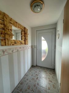 a hallway with a white door and a mirror at Ferienwohnung Levin in Dargun