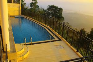 a swimming pool on the balcony of a building at Hotel Sky Gate kandy in Kandy
