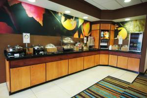 a restaurant kitchen with a counter with food at Fairfield Inn and Suites by Marriott Bartlesville in Bartlesville