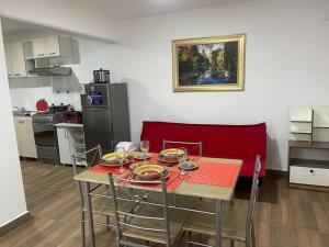 a kitchen with a table with plates and wine glasses on it at (24)Dpto de estreno en el corazón de Miraflores in Lima