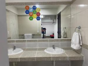 a bathroom with two sinks and a large mirror at (24)Dpto de estreno en el corazón de Miraflores in Lima