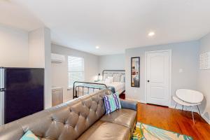 a living room with a couch and a bed at The Heights Garden Cottage in Houston