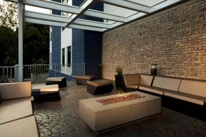 a patio with a fire pit and a brick wall at SpringHill Suites by Marriott Chester in Chester