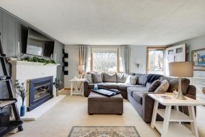 a living room with a couch and a fireplace at Picturesque Barnstable Rental with Deck and Backyard! in Barnstable