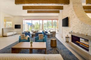 a living room with a fireplace and a stone wall at Residence Inn by Marriott Phoenix Chandler/South in Chandler