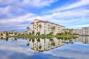 a building with its reflection in a body of water at Residence Inn by Marriott Phoenix Chandler/South in Chandler