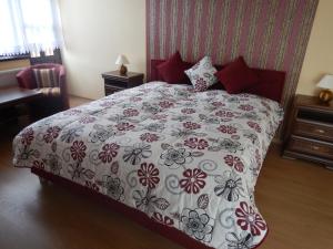 A bed or beds in a room at Konsky Dvor