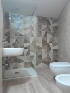 a bathroom with a sink and a toilet at La Coccola in Leporano