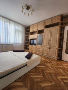 - une chambre avec un grand lit et des placards en bois dans l'établissement La Hasienda de Isabela, à Sofia