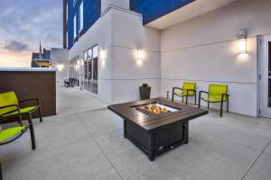 patio z kominkiem i krzesłami oraz budynek w obiekcie SpringHill Suites by Marriott Pittsburgh Butler/Centre City w mieście Butler