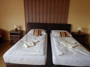 A bed or beds in a room at Konsky Dvor