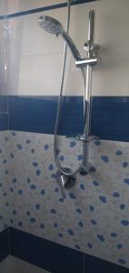 a shower in a bathroom with a tile floor at Villa Ermes in Lido Di Fondi