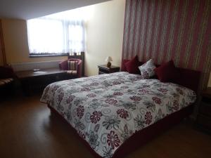 A bed or beds in a room at Konsky Dvor