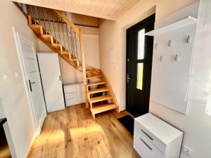 a room with a spiral staircase in a house at Apartament na Ogrodowej - 2 sypialnie, ogród, taras, parking in Trzęsacz +11 photos