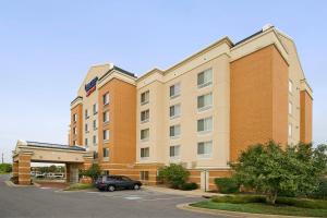 a hotel with a car parked in a parking lot at Fairfield Inn & Suites Germantown Gaithersburg in Germantown