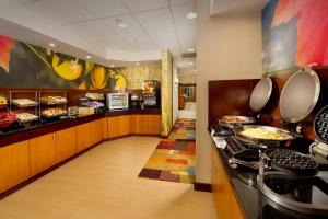a kitchen with a buffet of food in a restaurant at Fairfield Inn & Suites Germantown Gaithersburg in Germantown