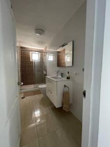 a bathroom with a sink and a toilet and a shower at Casa Brisa del mar in La Jaca