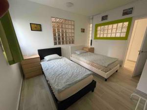 a bedroom with two beds and a window at Casa Brisa del mar in La Jaca