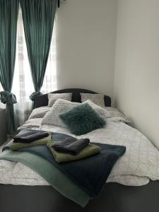 a bed with pillows on it in a bedroom at Sophie’s Urban Nest in Miskolc