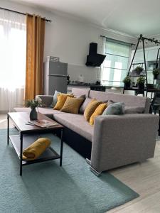 a living room with a couch and a table at Sophie’s Urban Nest in Miskolc