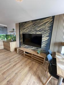 a living room with a large flat screen tv at LUXURY GOLD APARTMENT by Marta in Radom