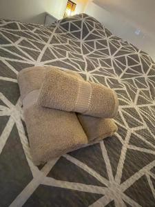 a pile of towels sitting on top of a bed at LUXURY GOLD APARTMENT by Marta in Radom