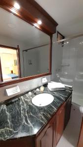 a bathroom with a sink and a mirror at Travelers Castellón De Juanambú in Cali