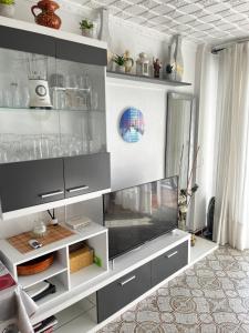 a living room with a flat screen tv at Apartamento en primera linea de playa con vistas in Puerto de Mazarrón