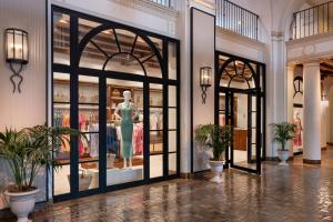 a lobby with glass doors with a mannequin in a store at The Vinoy Resort & Golf Club, Autograph Collection in St Petersburg