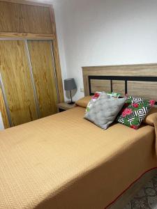a bedroom with a bed with two pillows on it at Apartamento en primera linea de playa con vistas in Puerto de Mazarrón