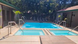 a swimming pool in a yard next to a house at Makhato Bush Lodge 48 in Bela-Bela