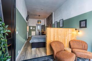 ミデルブルフにあるBelle Histoire Middelburgの椅子2脚とベッド1台が備わる客室です。