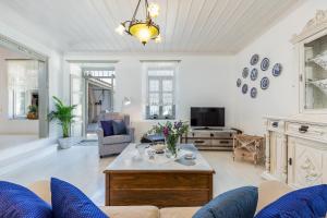 a living room with a couch and a table at Archodiko Palio Klima - Infinite Blue Elegance in Neo Klima
