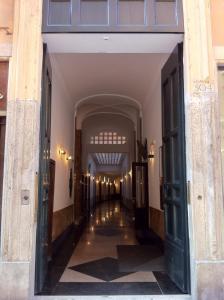 an empty hallway in a building with doors open at Lata Luxury Rooms in Rome