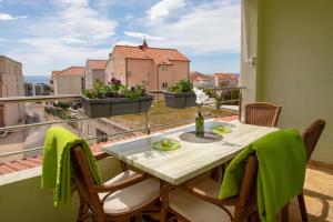 a table and chairs on a balcony with a view at Apartman Adriatic Sea in Promajna