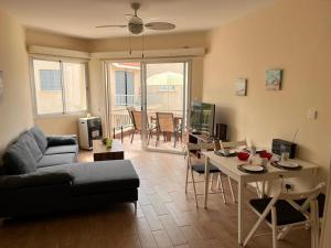 a living room with a couch and a table at Diamond Complex in Paphos