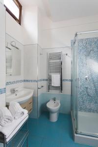a bathroom with a toilet and a sink and a shower at Ad un passo dal Duomo in Orvieto +62 photos