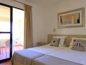 a bedroom with a large bed and a window at Apartamentos Quinta Mae dos Homens in Funchal