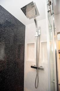 a shower with a glass door in a bathroom at Sherwood Pines - Big Garden! in Clipstone