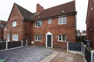 a brick house with a driveway in front of it at Sherwood Pines - Big Garden! in Clipstone