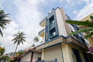 a house with a blue and white building at OYO Home Pop Tavern Pettah in Chacka