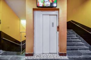 Una puerta blanca con TV encima. en Super OYO Hotel Priyal Amrit Sagar en Rourkela