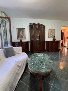 a living room with a bed and a glass table at 4M Apartments in Petrovac na Moru