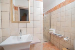 a bathroom with a sink and a mirror at Tsaner Apartment and Rooms in Matala