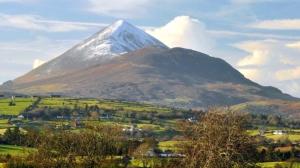 a snow capped mountain in the middle of a field at Dun Maeve Guesthouse in Westport +19 photos