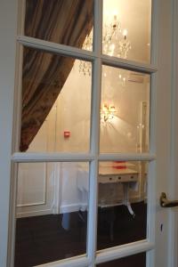 a window view of a desk in a room at Pand 17 - Charming Guesthouse in Bruges