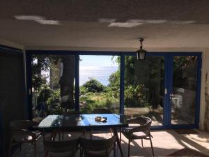 a table and chairs on a patio with a view of the ocean at Mediterranean Beach House in Perazića Do