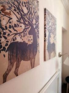a painting of a deer on a wall at Casa Clementina in Pisa