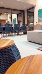 a dining room with blue chairs and a table at Milagres Hospedagens - Praia e Vista Coqueiros in São Miguel dos Milagres +80 photos