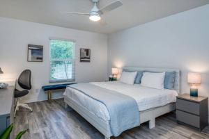 een slaapkamer met een bed, een bureau en een raam bij River's Edge Retreat in St. Augustine